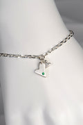 Sterling silver double heart bracelet set with emerald displayed on white mannequin wrist to show size and scale from the From The Heart collection by Christine Sadler