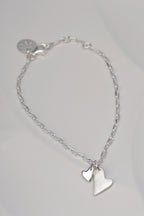 Sterling silver bracelet with two heart charms – one brushed, one polished – symbolising emotional connection from the From The Heart collection by Christine Sadler