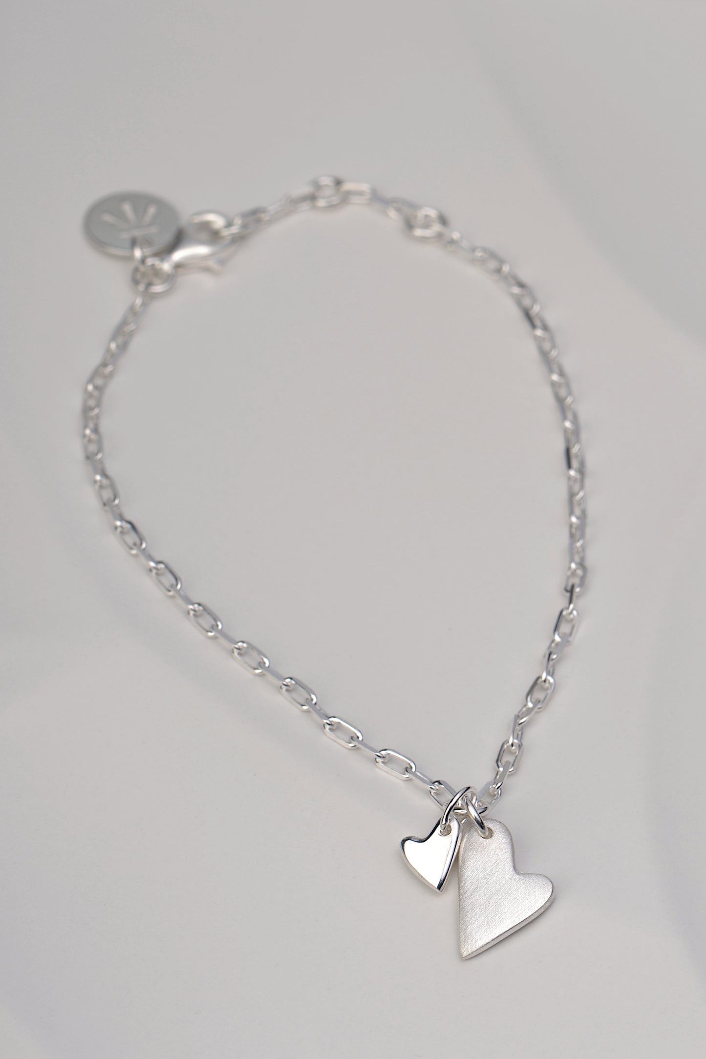 delicate real silver handmade bracelet with two hearts from jewellery designer Christine Sadler