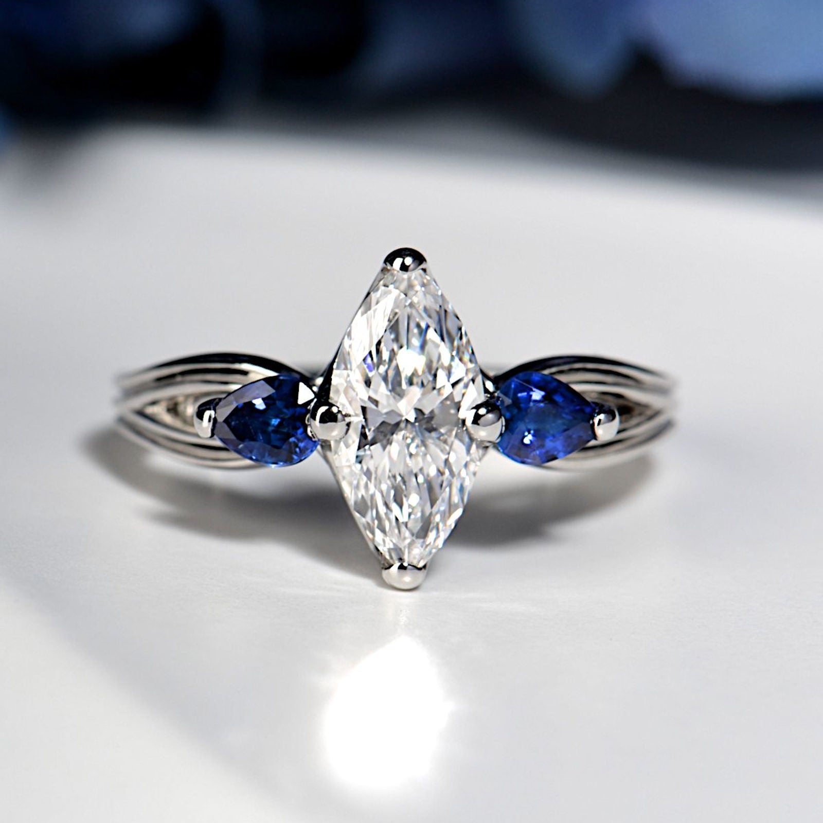 platinum sapphire and diamond marquise cut engagement ring, one-of-a-kind from Christine Sadler on a white background