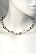 Sterling silver statement necklace with eleven DNA helix links and twelve oval thread-shaped links, designed by Christine Sadler.