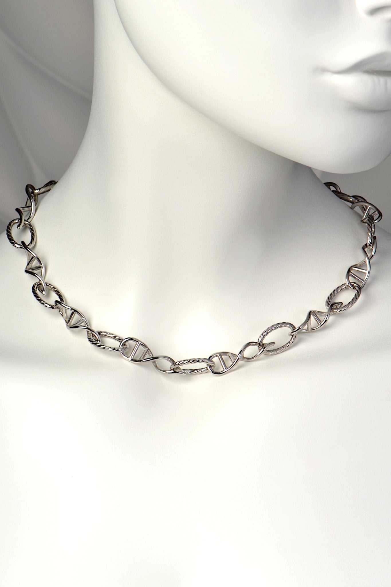 Sterling silver statement necklace with eleven DNA helix links and twelve oval thread-shaped links, designed by Christine Sadler.