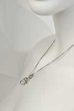 side view of the alternative styling of the silver helix pendant showing that it sits flat and close to the body - Christine Sadler