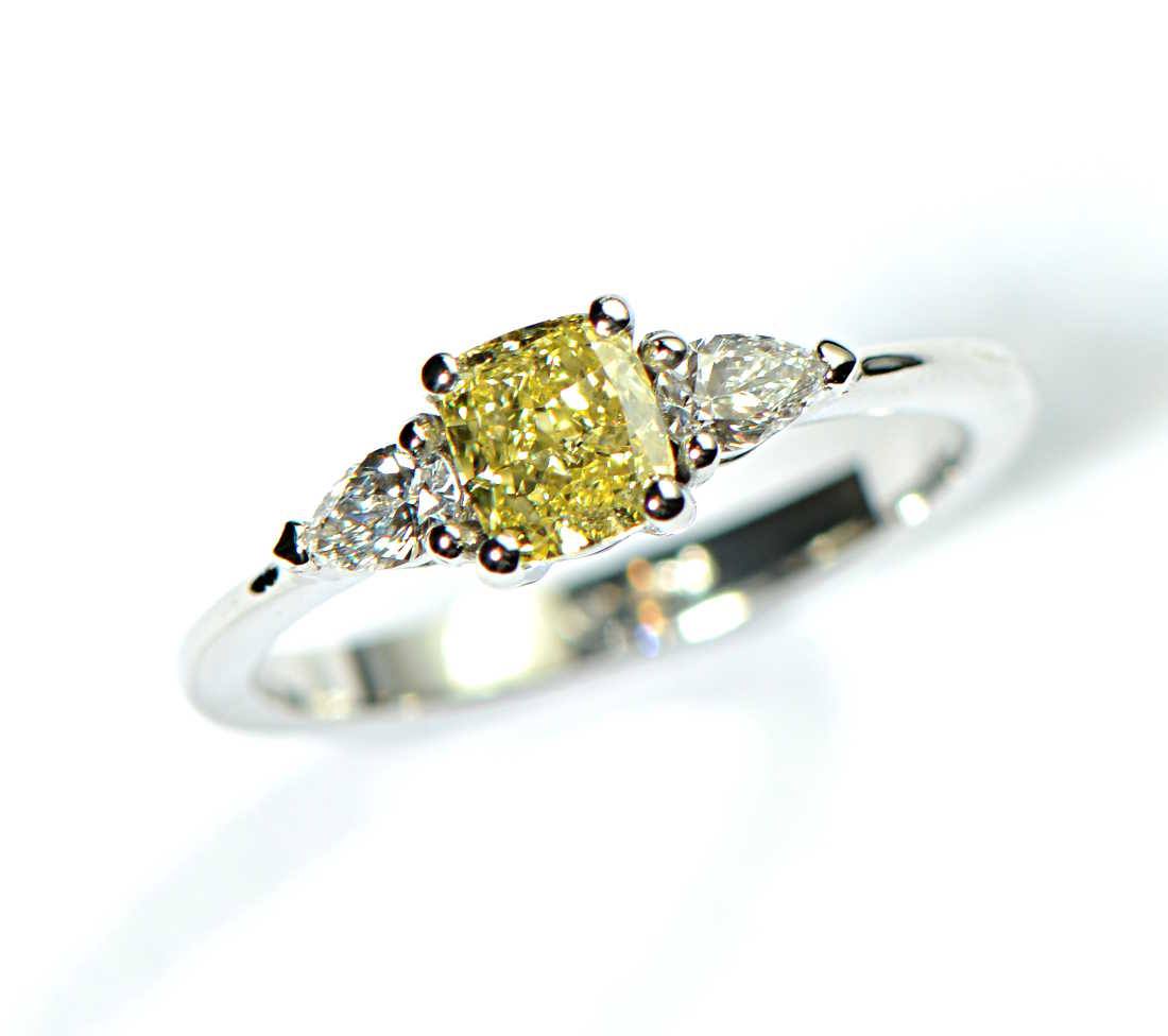 yellow cushion cut diamond with white pear cut diamonds on either side platinum engagement ring - Christine Sadler