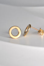 real gold round earrings with the earring post at the top of the ear