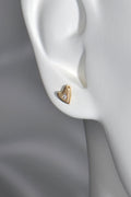 9ct yellow gold heart stud earrings with flush-set diamonds in a mannequin ear to show size and scale.