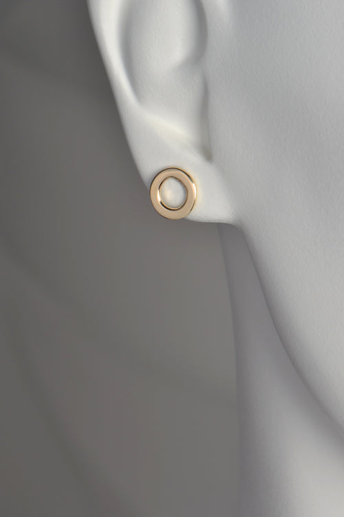 a circle of gold earrings with a space in the middle . They are 10mm in diameter and the bottom of the earring sits just below the earlobe. 
