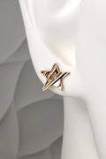 solid 9ct yellow gold star stud earring with a carved surface that catches the light and a circular hole in the middle, shown in a mannequin ear to demonstrate size and scale