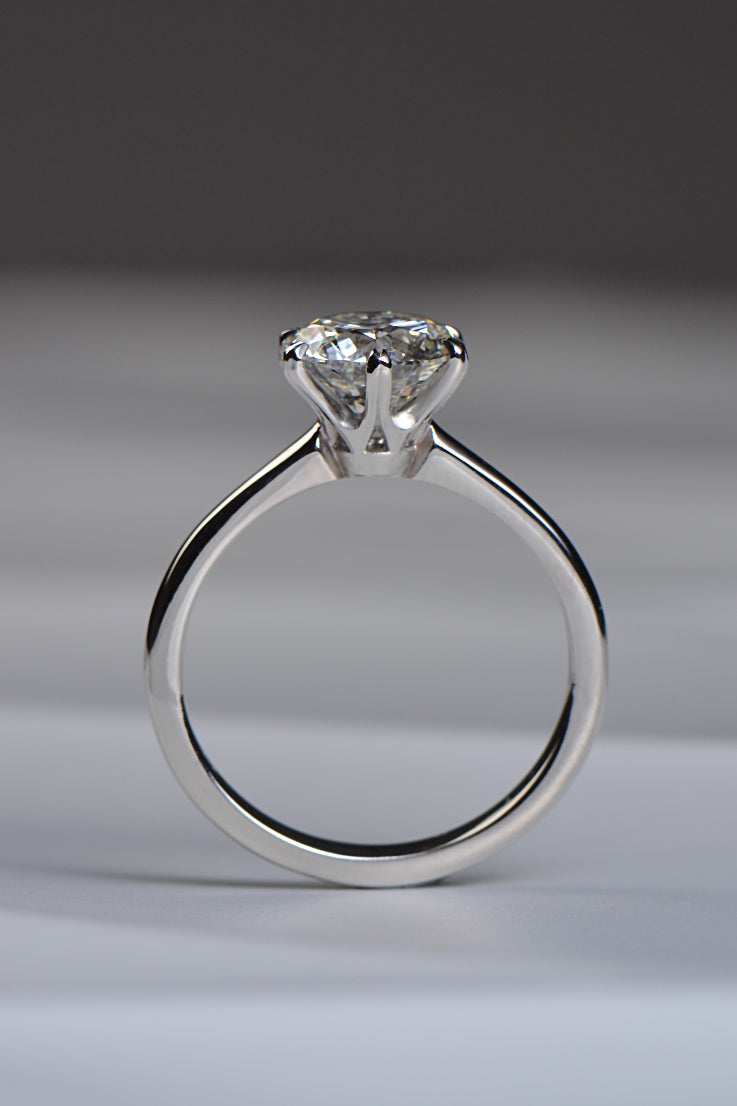 side view of 2 carat round brilliant cut diamond engagement ring made in platinum. 