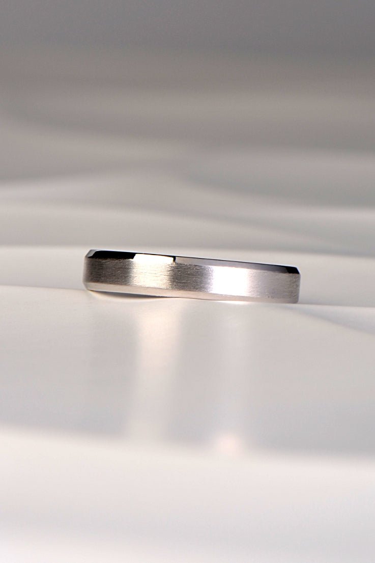 simple wedding ring for a man or woman with a modern matt finish and a polished chamfered edge