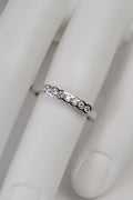 modern narrow diamond set wedding ring in platinum made in the UK set with seven diamonds in secure rubbed over settings