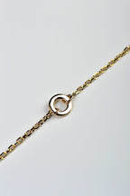 Handmade delicate gold bracelet with a circle at the front from British jewellery designer Christine Sadler