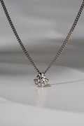 platinum designer lab grown necklace that is special and different set with one larger central stone surrounded on the bottom half by six smaller stones. The design is inspired by the Scottish Fairy Pools on the Isle of Skye exclusively available from Christine Sadler