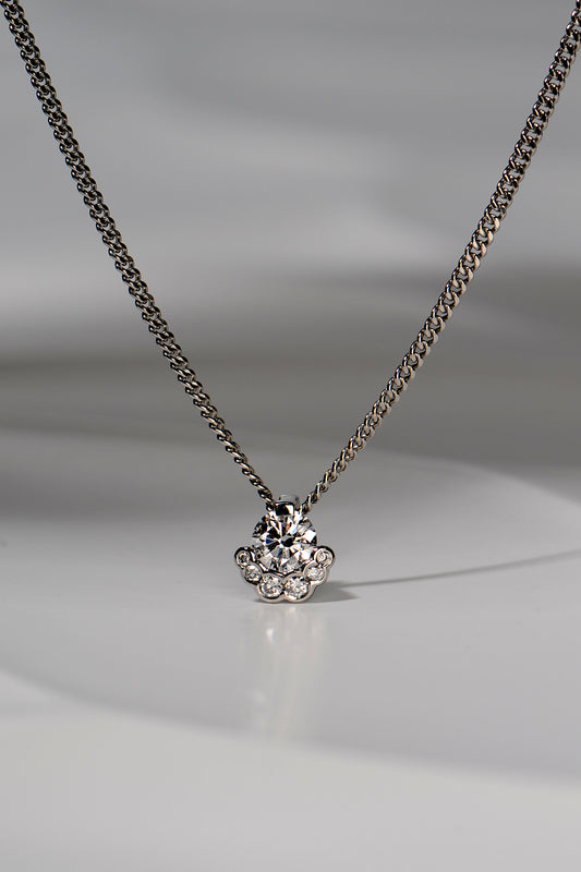 platinum designer lab grown necklace that is special and different set with one larger central stone surrounded on the bottom half by six smaller stones. The design is inspired by the Scottish Fairy Pools on the Isle of Skye exclusively available from Christine Sadler
