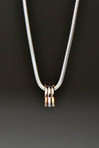 small silver, rose gold and yellow gold circles on a silver necklace from Christine Sadler Unforgettable Jewellery