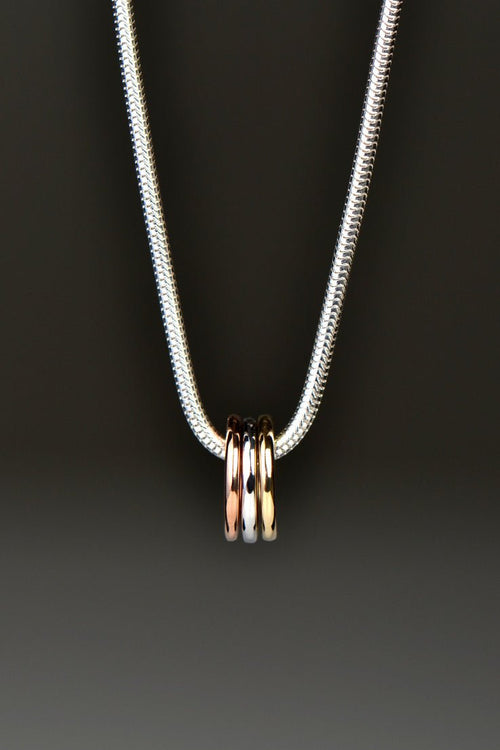 small silver, rose gold and yellow gold circles on a silver necklace from Christine Sadler Unforgettable Jewellery
