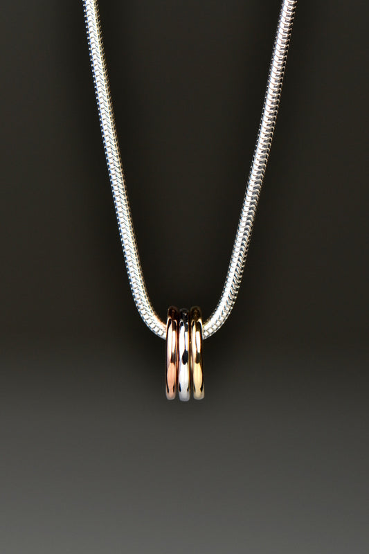 small silver, rose gold and yellow gold circles on a silver necklace from Christine Sadler Unforgettable Jewellery