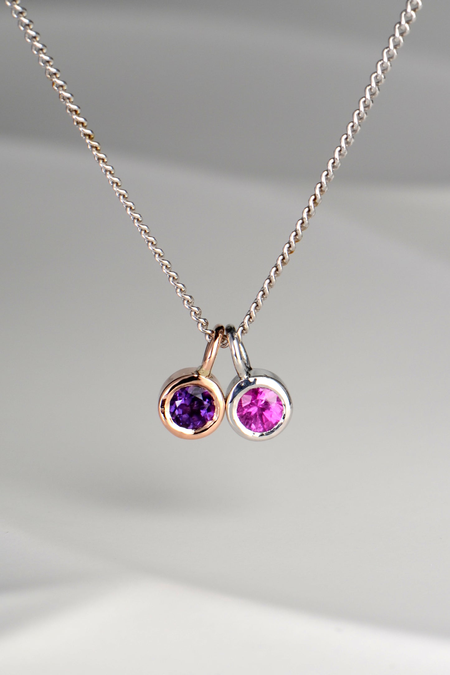 Cairn gold pendant with amethyst and pink sapphire