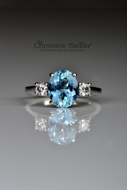 Platinum aquamarine and diamond three stone ring