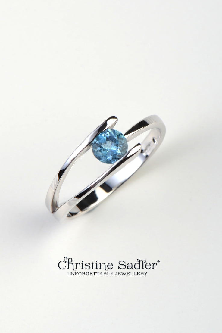 white gold modern designer ring with a round aquamarine