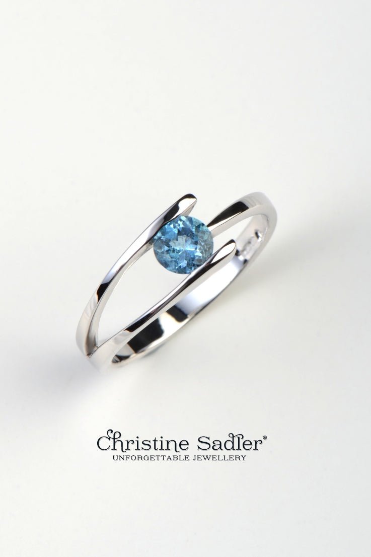 white gold modern designer ring with a round aquamarine inspired by fruit trees