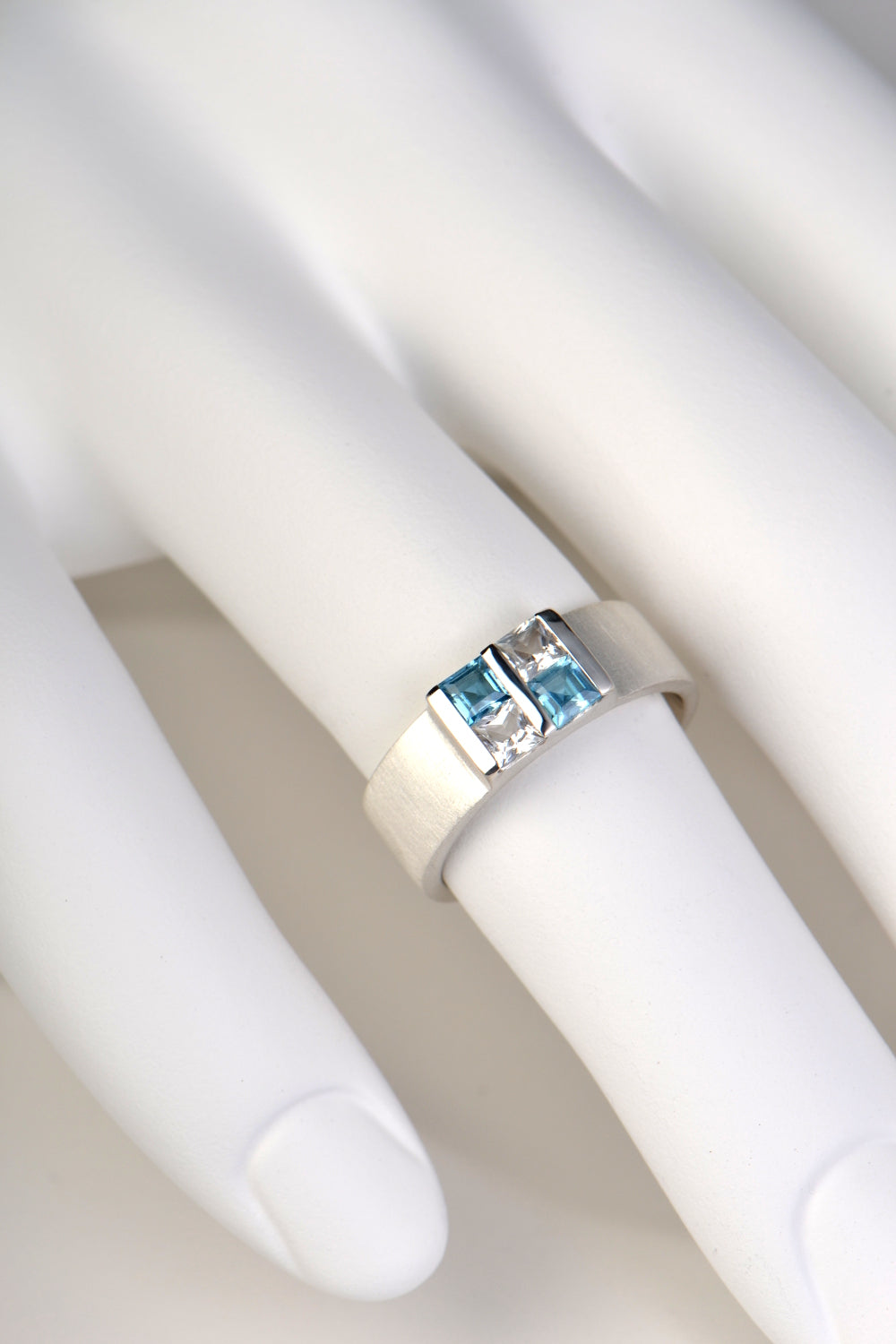 Battenberg ring with blue and white topazes