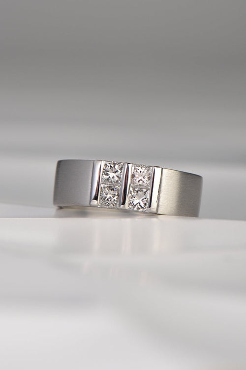 contemporary platinum and diamond princess cut ring inspired by battenberg cake. Four princess cut diamonds are set in a square pattern with polished bars on a wide platinum band. A Highly unusual design available exclusively from Christine Sadler