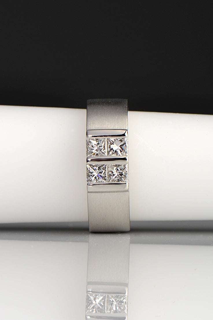 Contemporary platinum and diamond princess cut ring inspired by battenberg cake. Four princess cut diamonds form a square on top of a wide paltinum band
