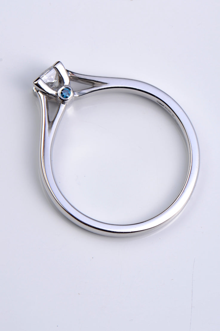 Platinum princess cut diamond ring with blue diamonds