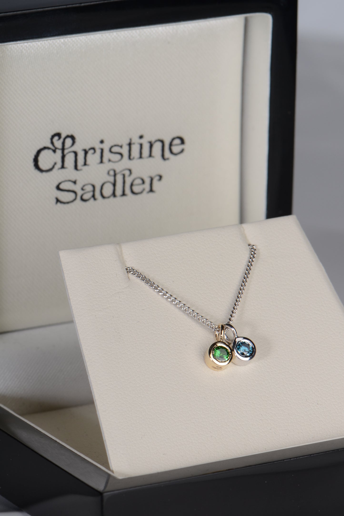 Cairn white gold blue diamond and green garnet necklace