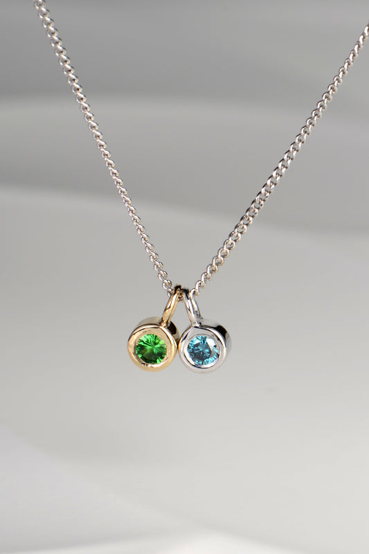 Cairn white gold blue diamond and green garnet necklace
