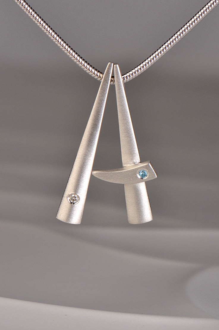 Cairn diamond and blue topaz pendant