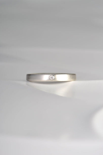 modern plain silver ring set with a diamond and matt finished