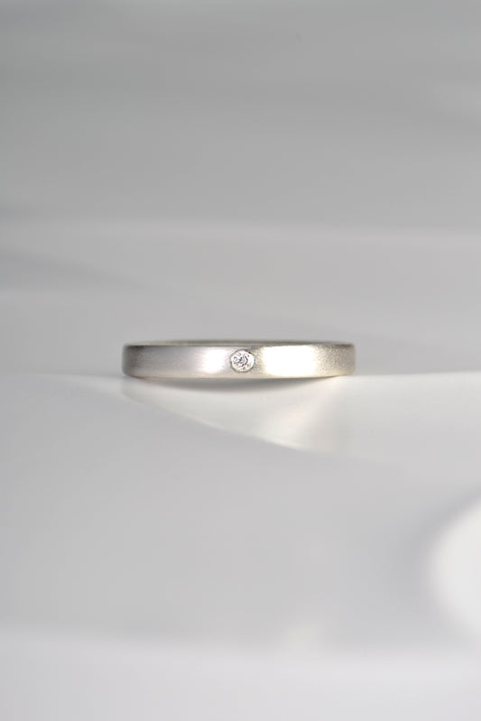 modern plain silver ring set with a diamond and matt finished
