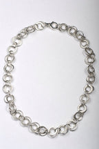 Handmade British sterling silver necklace with matt and polished interlinked circles all the way round