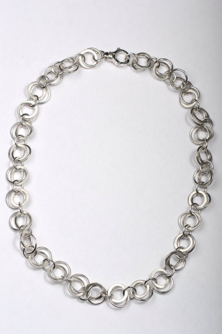 Handmade British sterling silver necklace with matt and polished interlinked circles all the way round