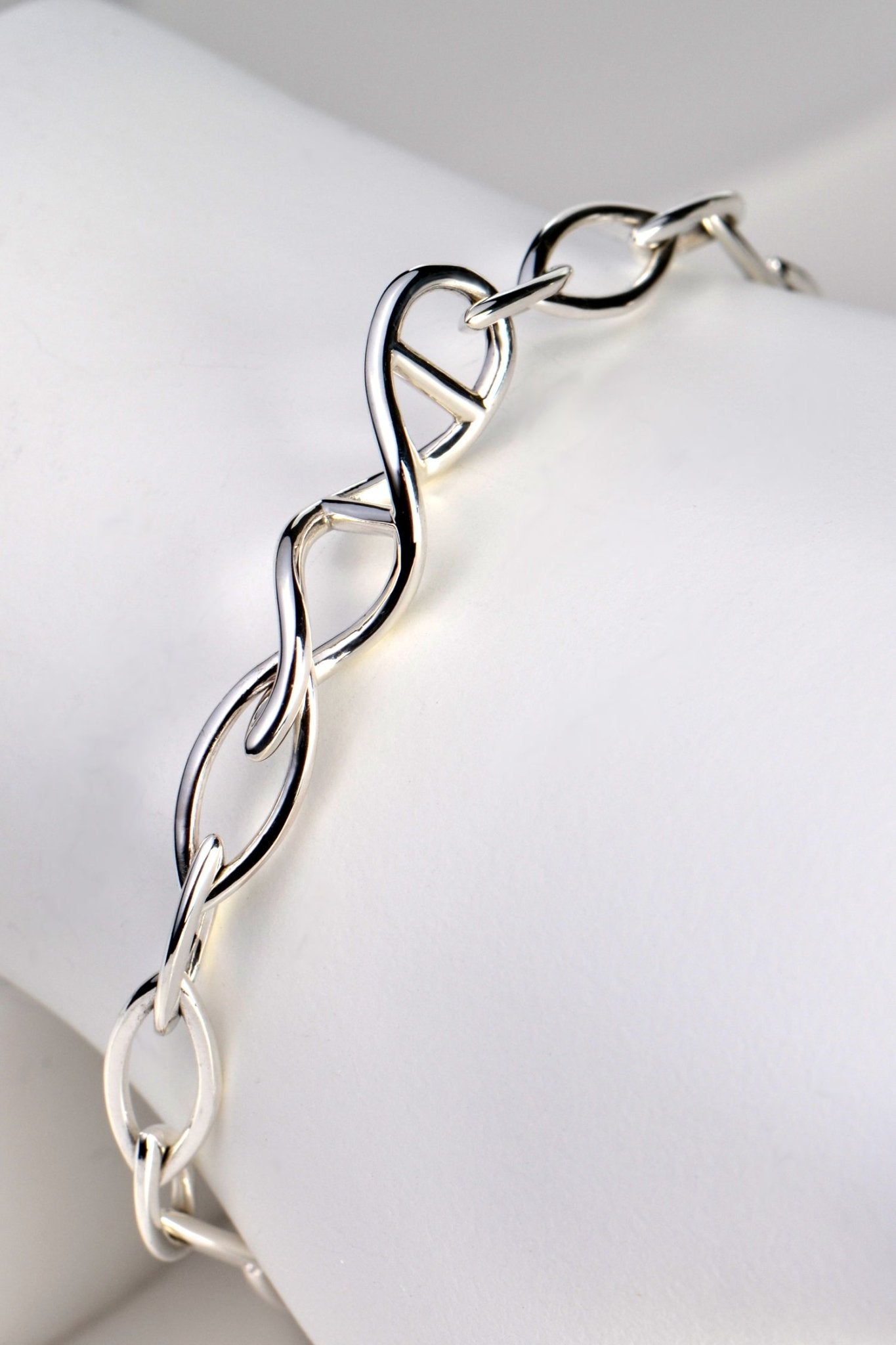 Sterling silver designer genes handmade bracelet with DNA helix link at the front and alternating elliptical links in 15mm and 12mm lengths. - Christine Sadler