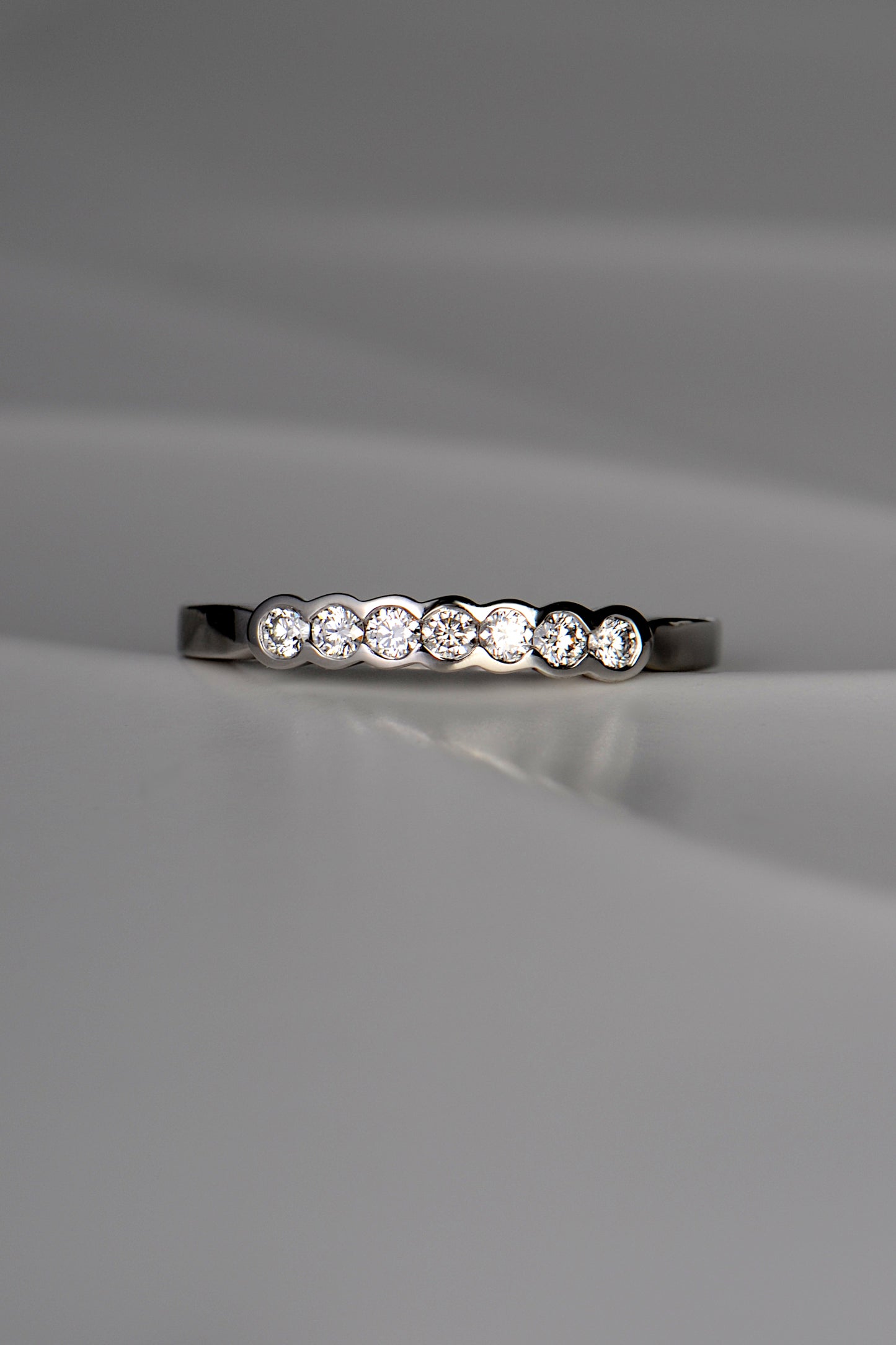 unusual modern platinum diamond set wedding ring with no claws handmade in the UK