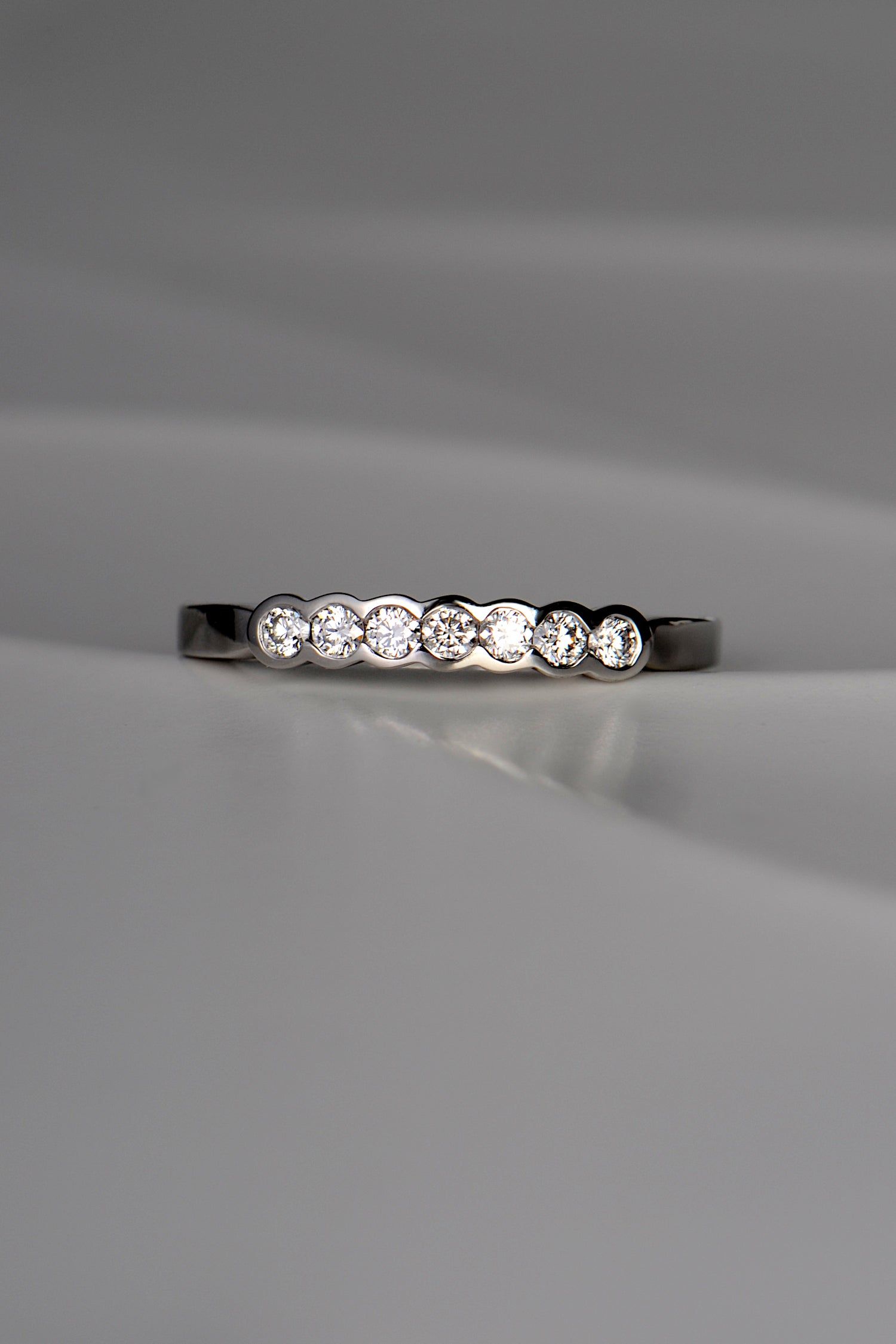 unusual modern platinum diamond set wedding ring with no claws handmade in the UK