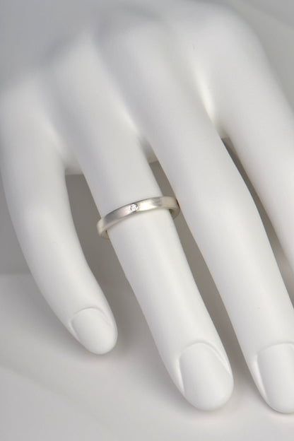 modern brushed finished silver ring set with a diamond from Christine Sadler