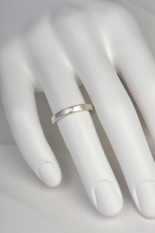 modern brushed finished silver ring set with a diamond from Christine Sadler