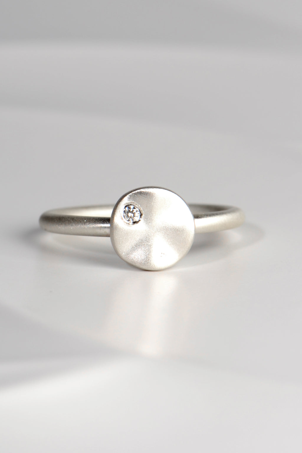 modern handmade silver ring with a ripple circle on top set with a diamond by Christine Sadler - jewellery to change the world