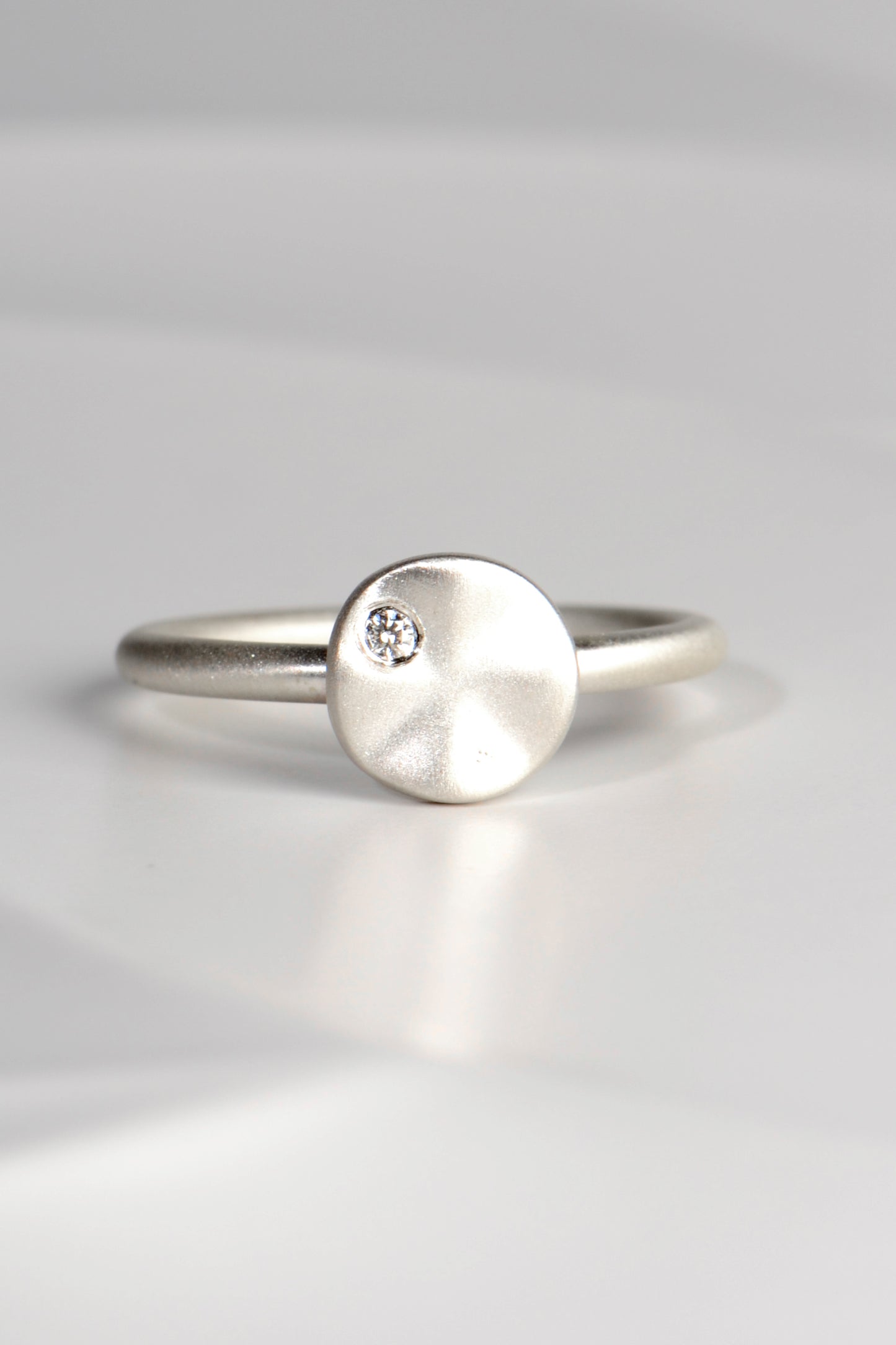 modern handmade silver ring with a ripple circle on top set with a diamond by Christine Sadler - jewellery to change the world