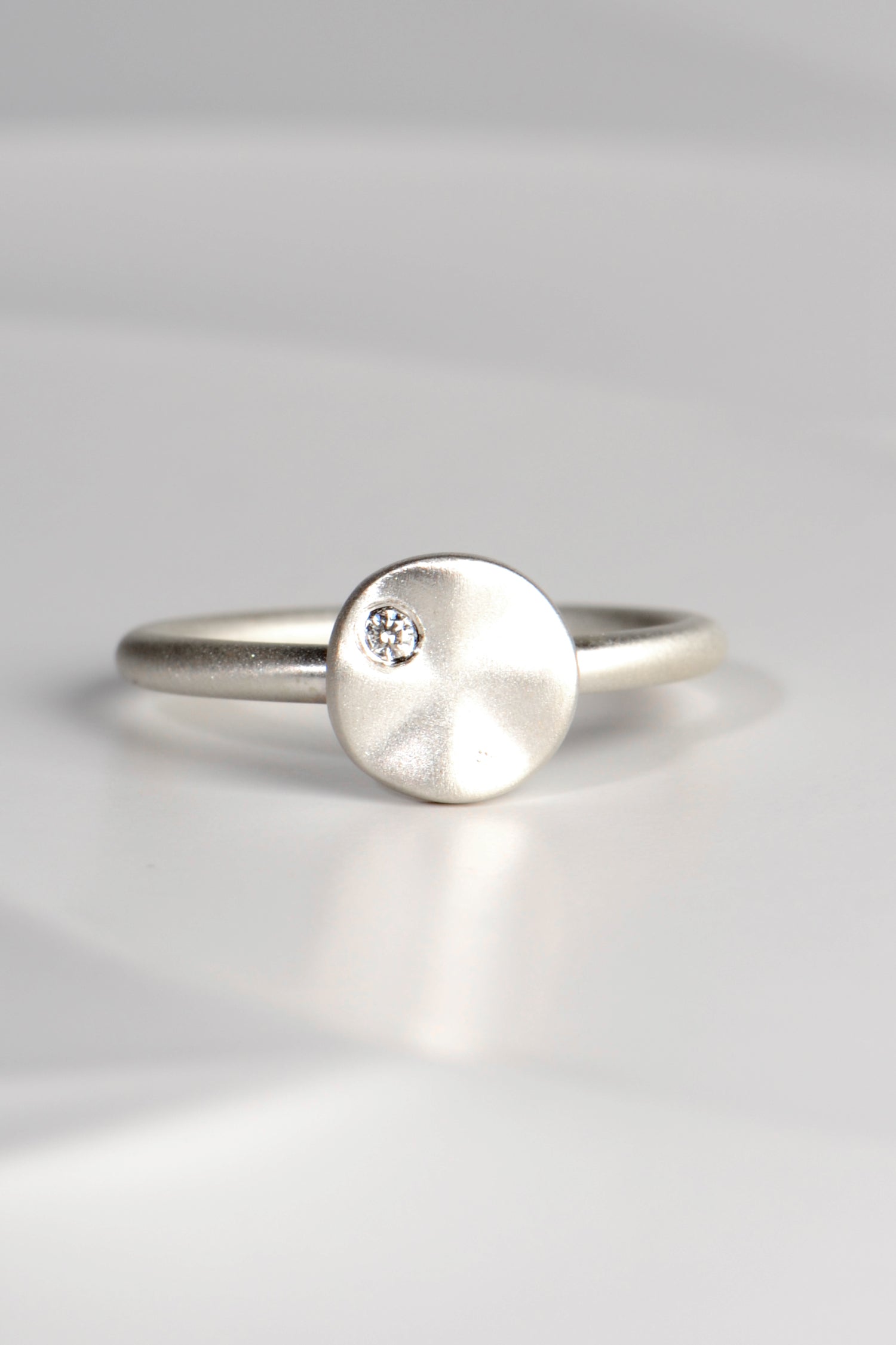 modern handmade silver ring with a ripple circle on top set with a diamond by Christine Sadler - jewellery to change the world