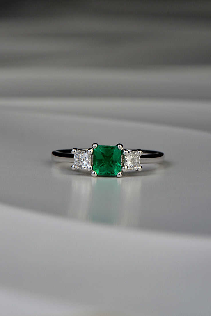 square cut emerald three stone ring with princess cut diamonds