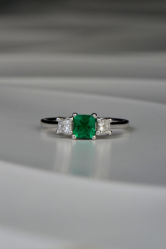 square cut emerald three stone ring with princess cut diamonds