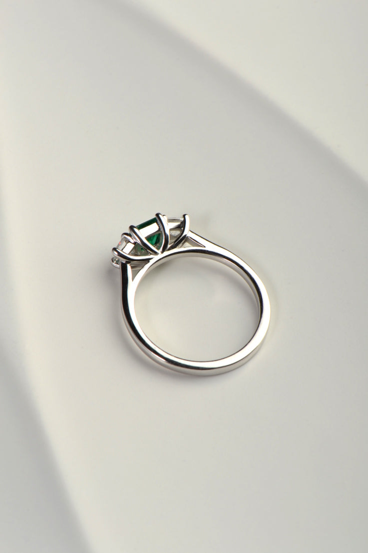 side view of emerald and diamond engagement ring