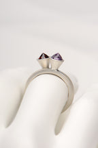 two silver rings stacked together with an amethyst and a garnet gemstone by british jewellery designer Christine Sadler