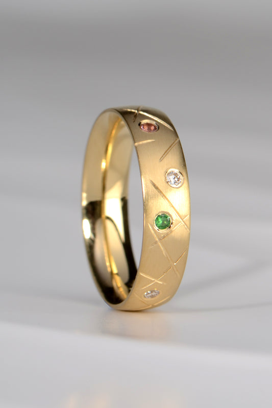 18ct designer gold band set with different coloured gemstones by scottish jewellery designer Christine Sadler