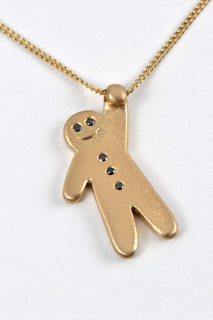 cute smiling gold gingerbread man necklace with black diamonds from British jewellery designer Christine Sadler